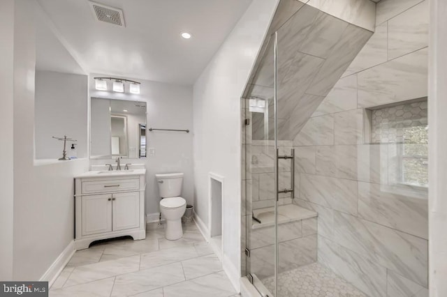 bathroom with vanity, toilet, and a shower with shower door