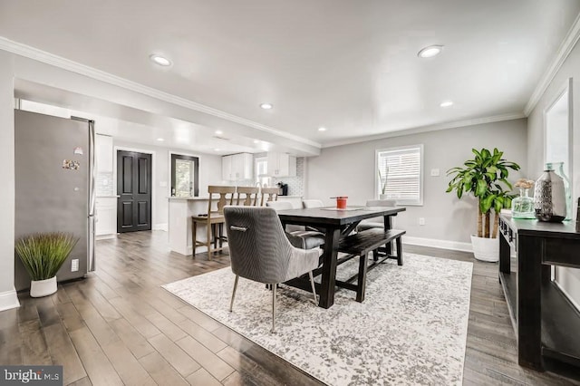 dining area featuring crown molding and dark hardwood / wood-style flooring