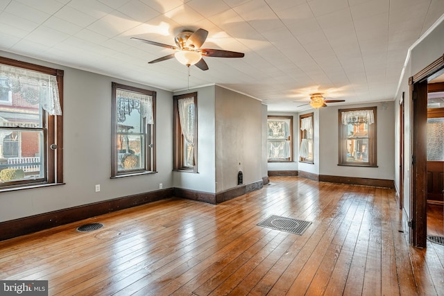 spare room featuring hardwood / wood-style flooring, a wealth of natural light, and ceiling fan