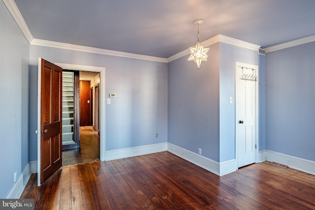 empty room featuring crown molding and dark wood-type flooring