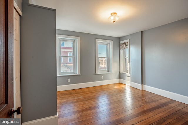 spare room with hardwood / wood-style flooring