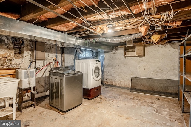 basement with washing machine and dryer and sink