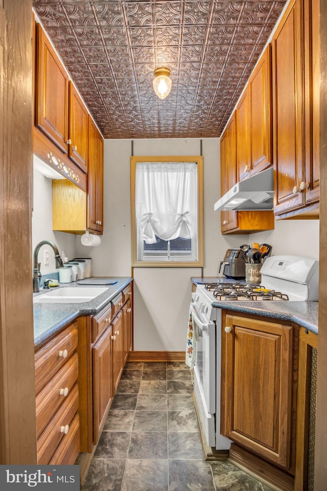 kitchen featuring sink and white gas range oven