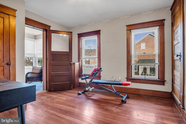 workout area with cooling unit and wood-type flooring