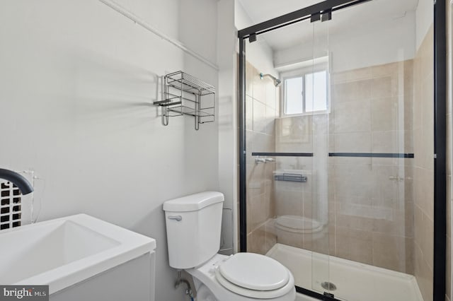 bathroom with toilet and walk in shower