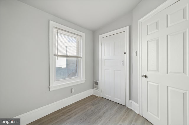 interior space featuring light hardwood / wood-style floors and lofted ceiling