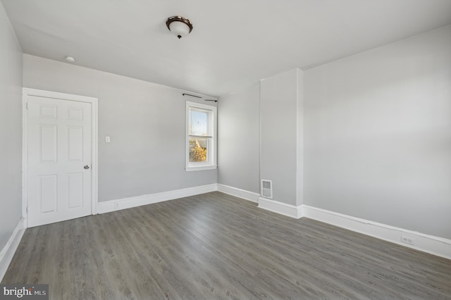 empty room with dark wood-type flooring