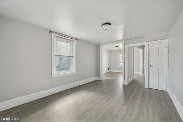 spare room featuring plenty of natural light and light hardwood / wood-style floors