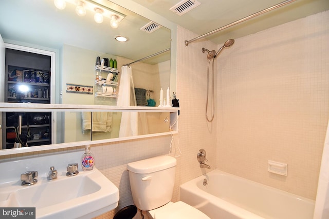 full bathroom featuring shower / tub combo with curtain, toilet, and sink