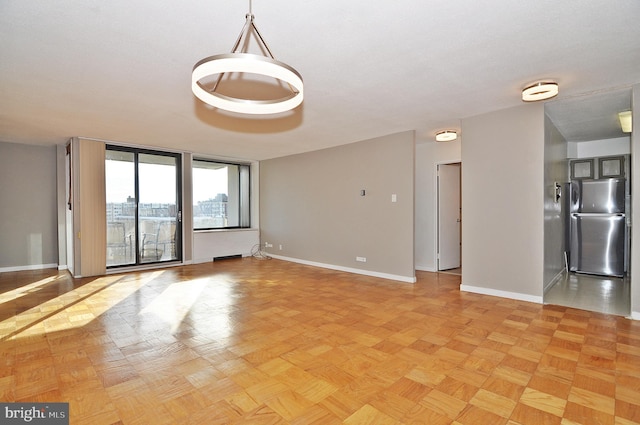 unfurnished room with light parquet flooring