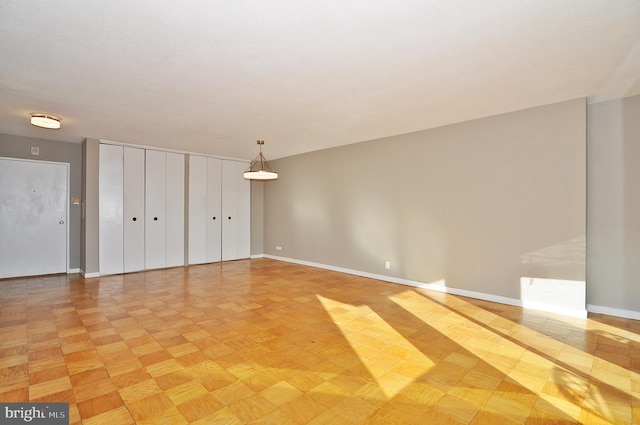 interior space featuring multiple closets and light parquet flooring