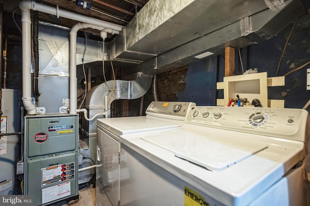 laundry room with independent washer and dryer and water heater