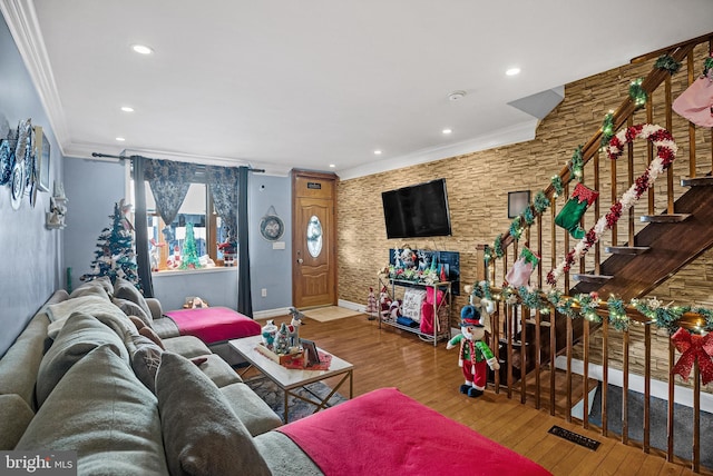 living room with hardwood / wood-style floors and crown molding