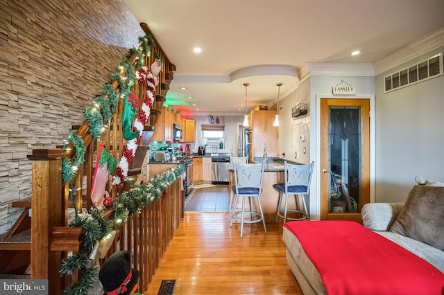 interior space featuring light hardwood / wood-style flooring and ornamental molding