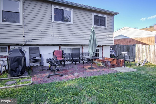 rear view of house featuring a lawn and a patio area