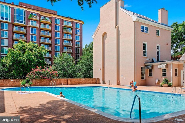 view of swimming pool with a patio