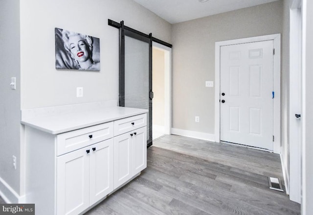 foyer featuring a barn door and light hardwood / wood-style floors