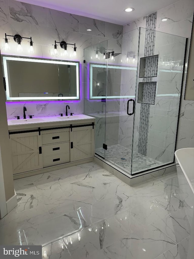 bathroom featuring shower with separate bathtub and vanity