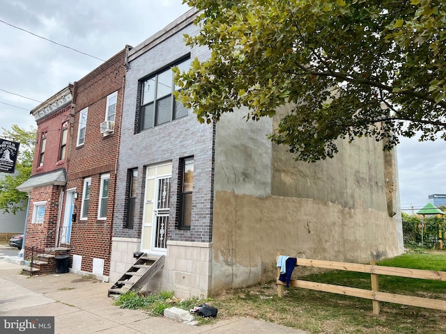 view of side of home featuring cooling unit