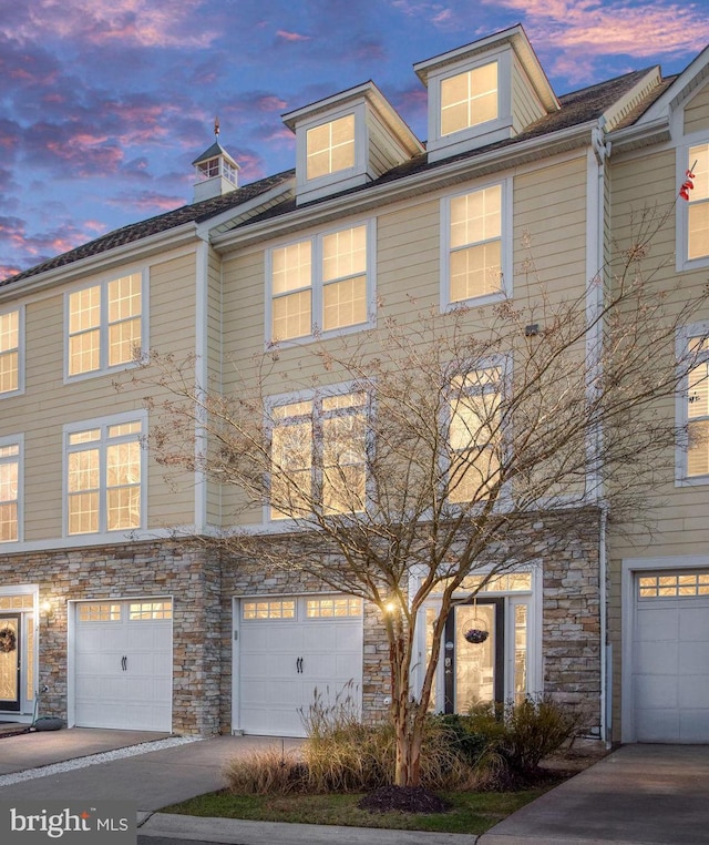 4 Bay View Ln, Colonial Beach, VA 22443 - townhome / multi-family property featuring stone siding, a garage, and driveway