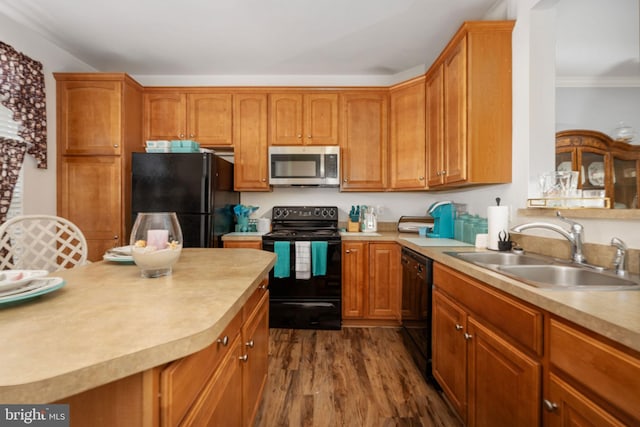 kitchen with black appliances, crown molding, dark hardwood / wood-style flooring, and sink