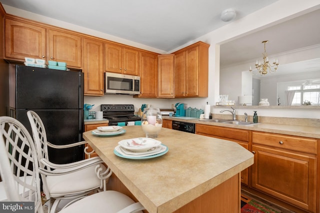 4 Bay View Ln, Colonial Beach, VA 22443 - kitchen with black appliances, a sink, a chandelier, light countertops, and a center island