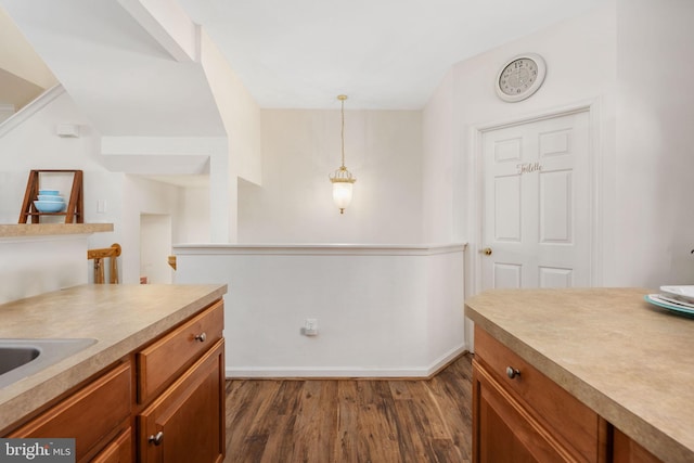 4 Bay View Ln, Colonial Beach, VA 22443 - kitchen with brown cabinetry, dark wood-style flooring, light countertops, and decorative light fixtures