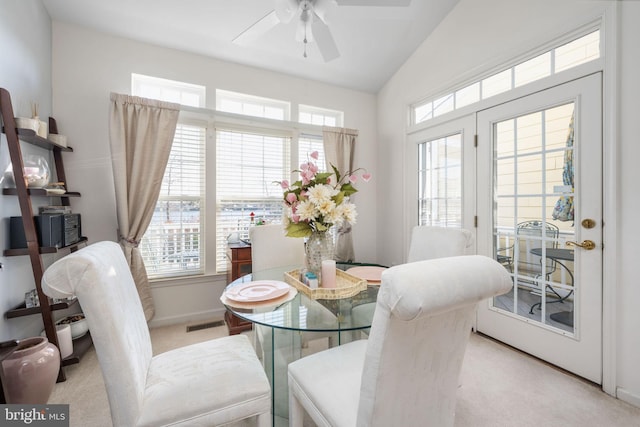 dining area featuring light colored carpet, ceiling fan, and lofted ceiling