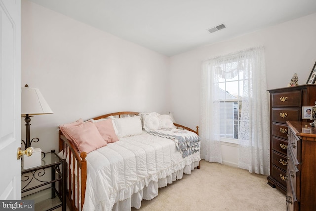 bedroom with light colored carpet