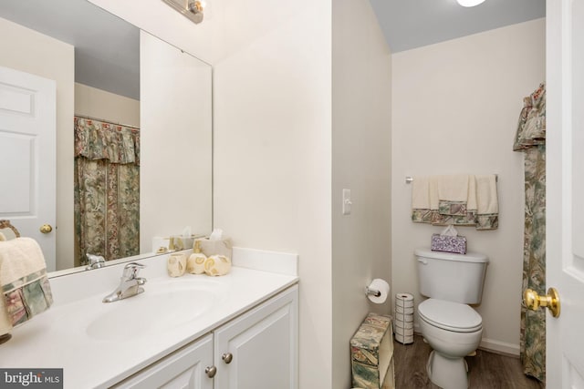 bathroom with vanity, hardwood / wood-style flooring, and toilet