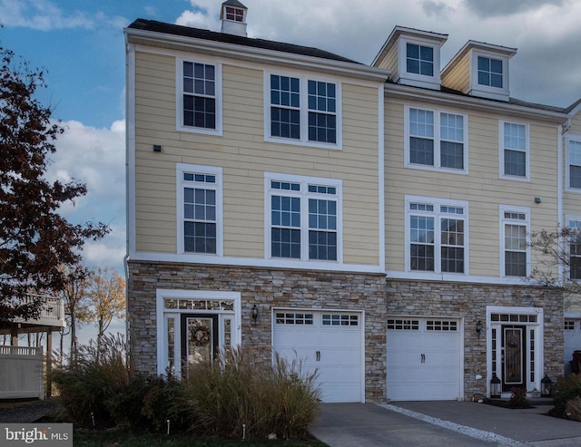 townhome / multi-family property featuring a garage