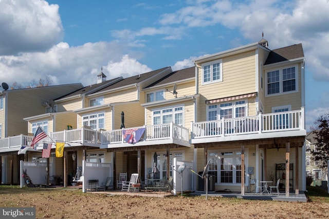 back of house featuring a wooden deck