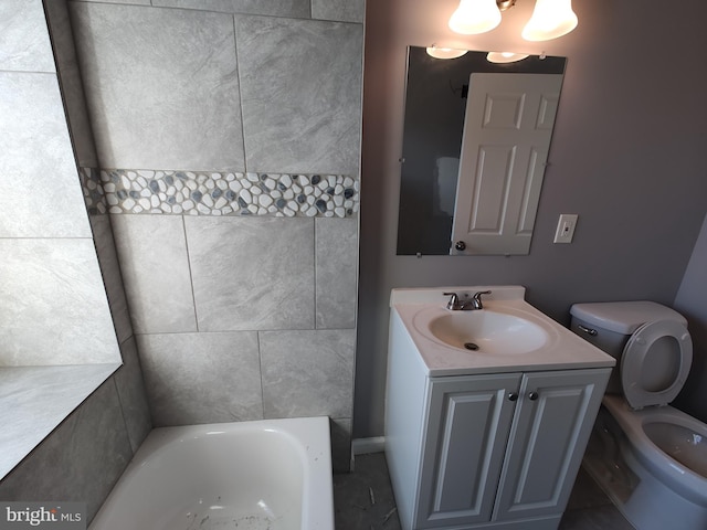 bathroom with vanity, toilet, and a tub