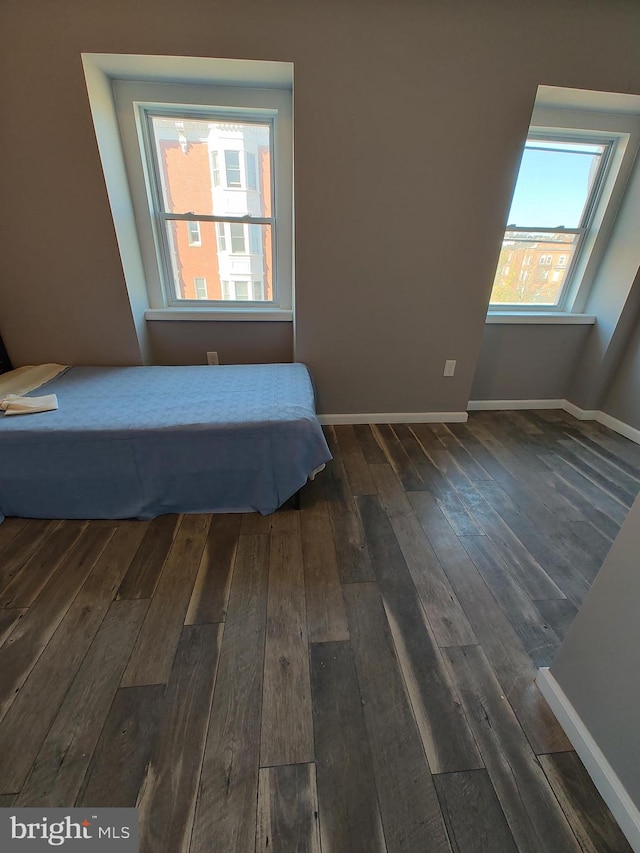 unfurnished bedroom featuring dark wood-type flooring