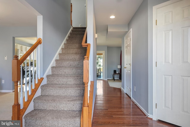 stairs with hardwood / wood-style flooring