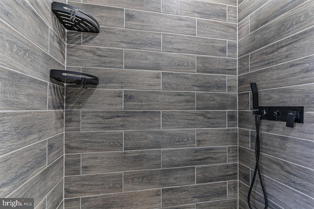 bathroom with a tile shower