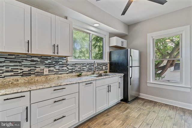 kitchen with white cabinetry, sink, and a healthy amount of sunlight