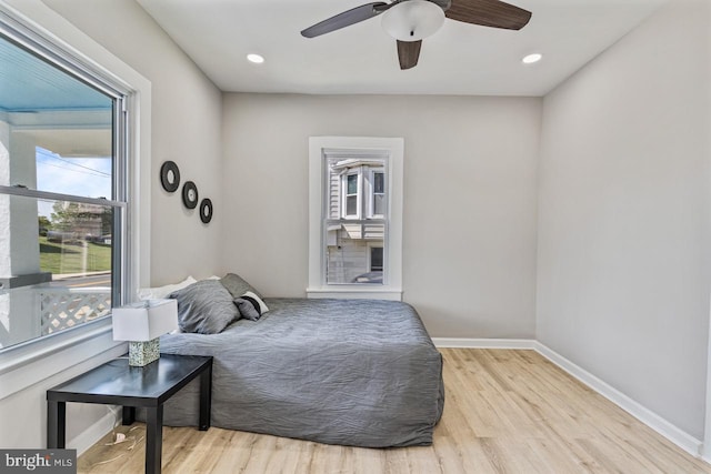 bedroom with ceiling fan and light wood-type flooring