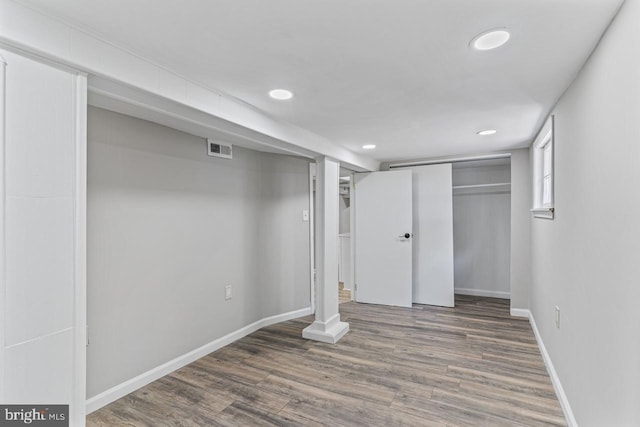 basement featuring dark hardwood / wood-style floors