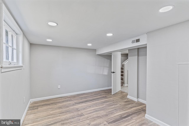 basement with light hardwood / wood-style floors