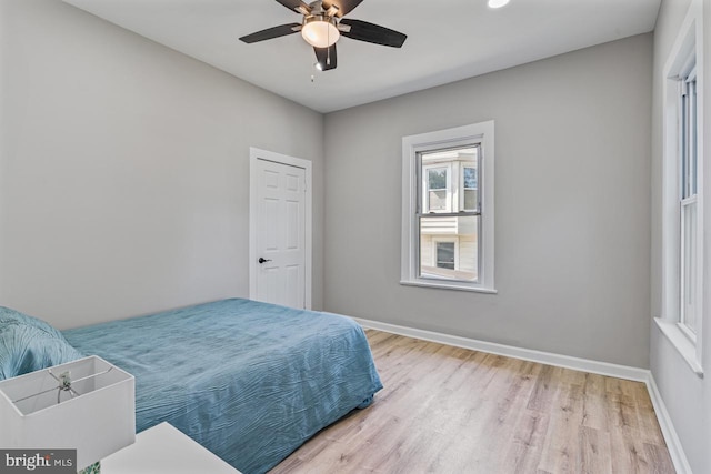 bedroom with ceiling fan and light hardwood / wood-style floors