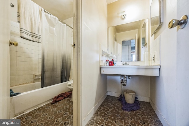 bathroom featuring tile patterned flooring, toilet, and shower / tub combo