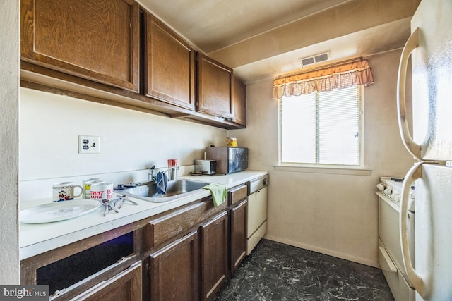 kitchen featuring sink and white appliances