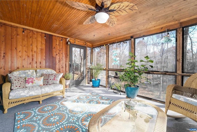 sunroom / solarium featuring ceiling fan and wood ceiling