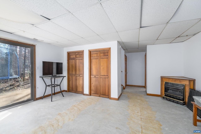 interior space featuring a paneled ceiling, access to outside, and two closets