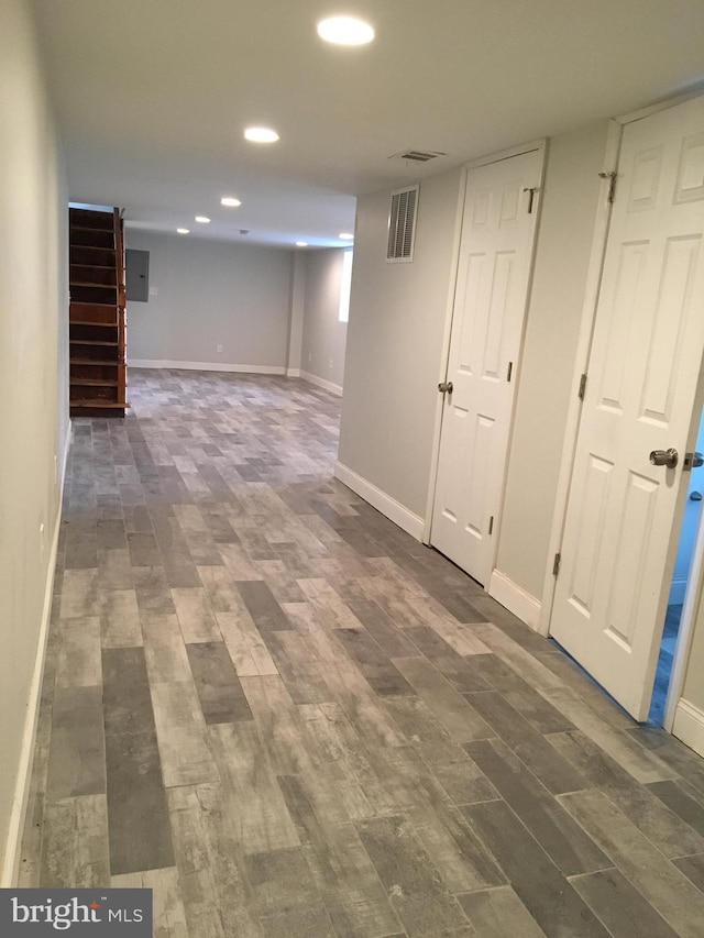 basement with dark hardwood / wood-style floors