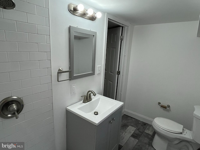 bathroom with hardwood / wood-style flooring, vanity, and toilet