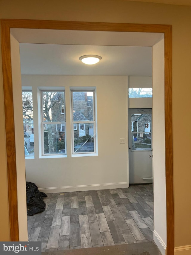 corridor with dark hardwood / wood-style flooring