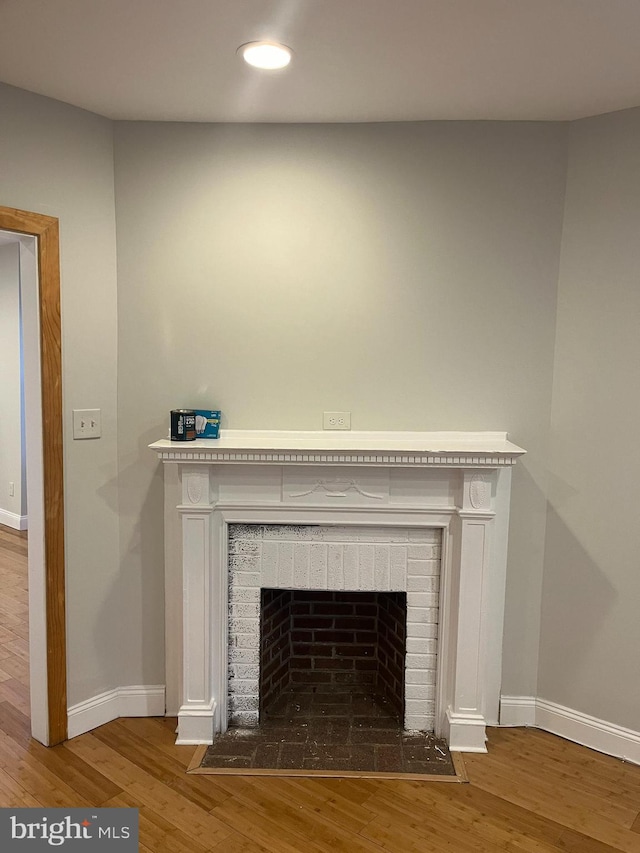 room details with a fireplace and hardwood / wood-style floors