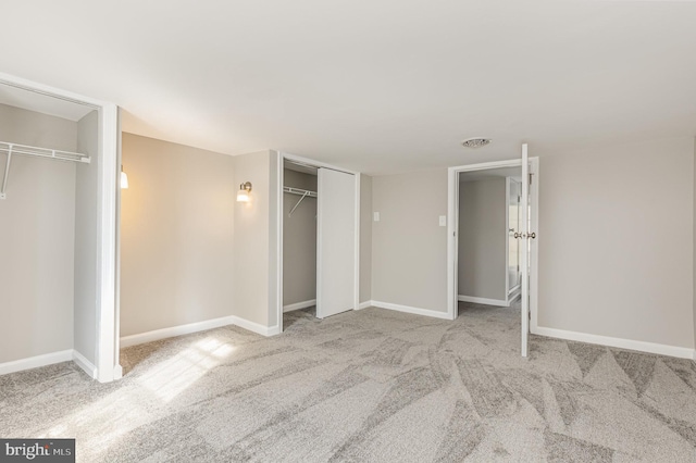 unfurnished bedroom featuring light carpet